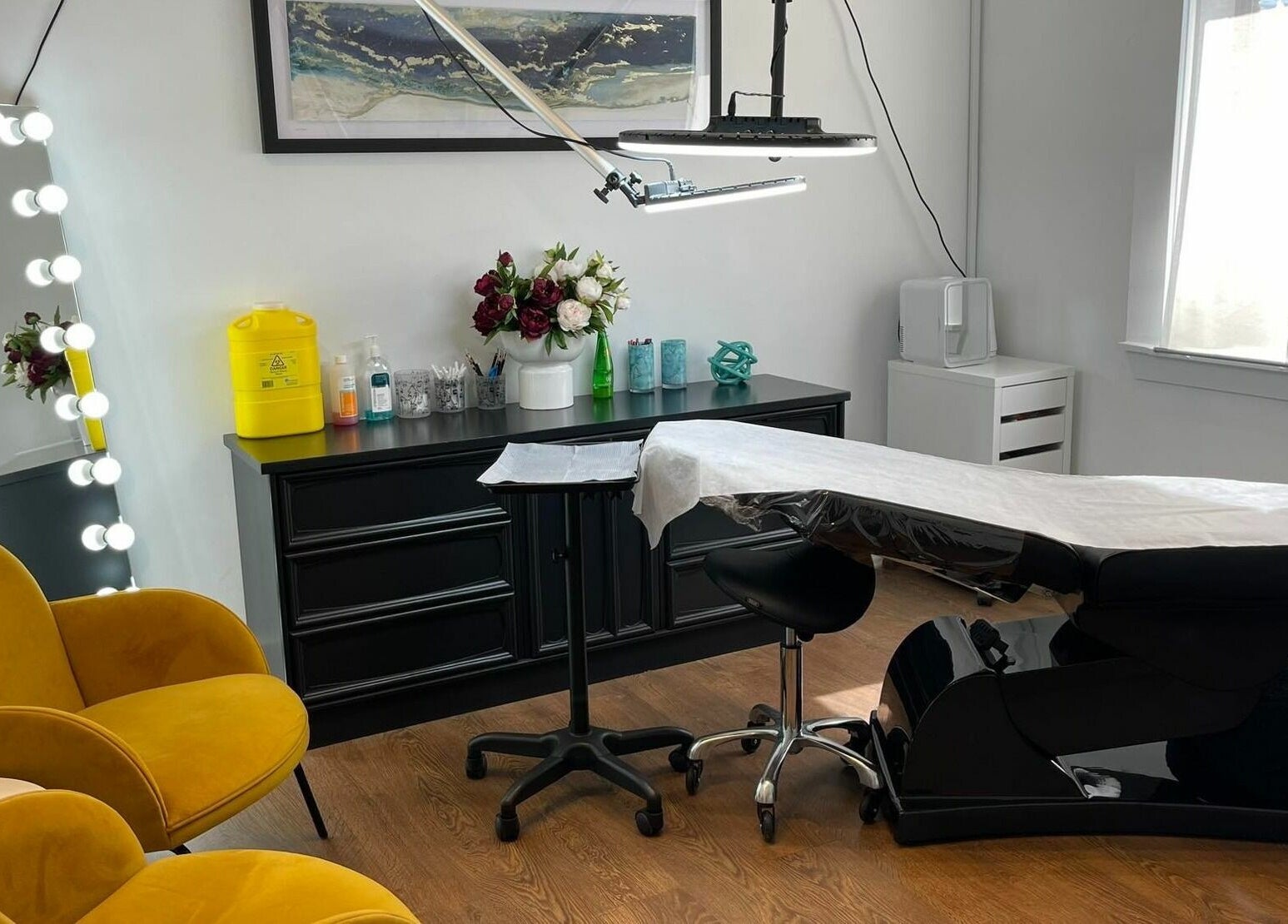 Stylish interior of Flutter Beauty Studio in Melbourne, Victoria, AU with modern chairs and equipped treatment area.