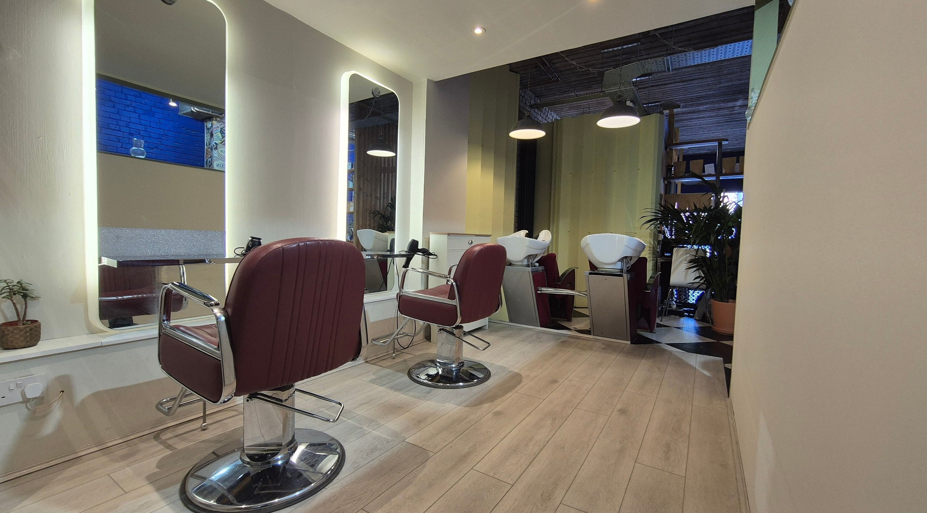 Modern styling chairs at Hair Stylist Arek Namyslowski, London, England, GB, offering a chic and relaxing ambiance.