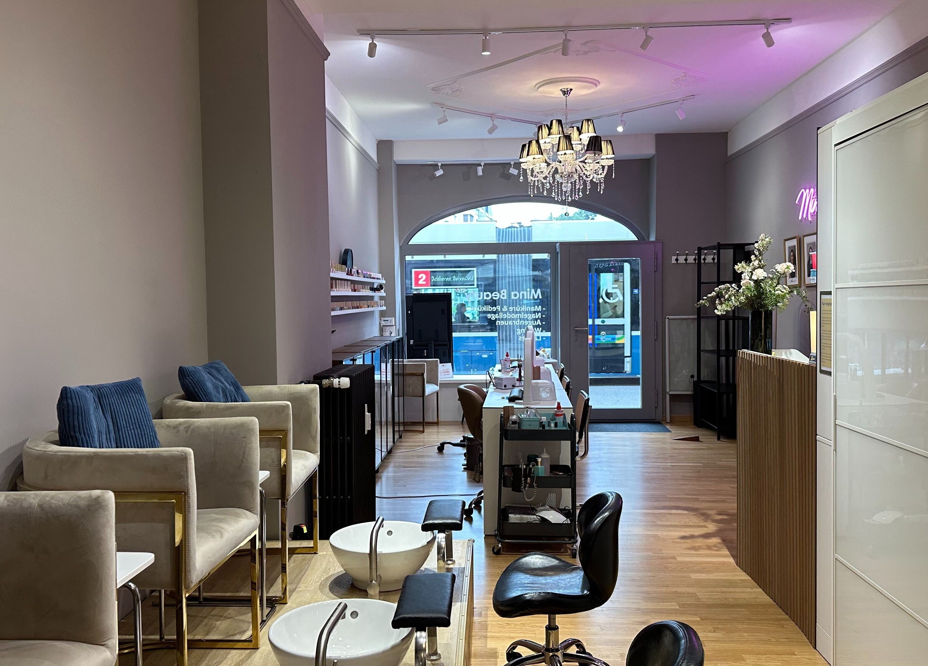 Interior of Mina Beauty Seefeld in Zürich, Zürich, CH showcasing nail stations and chic decor.
