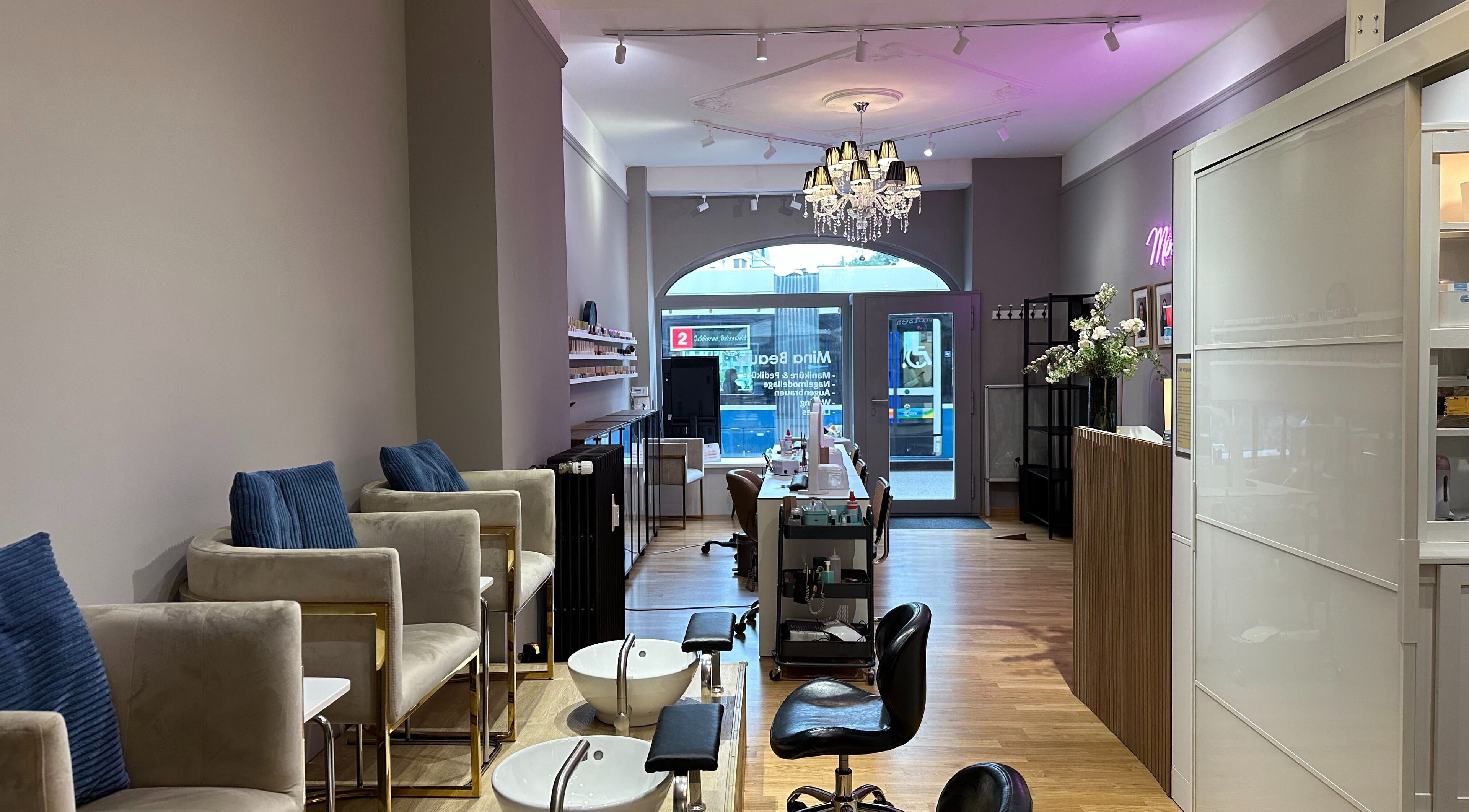 Interior of Mina Beauty Seefeld in Zürich, Zürich, CH showcasing nail stations and chic decor.