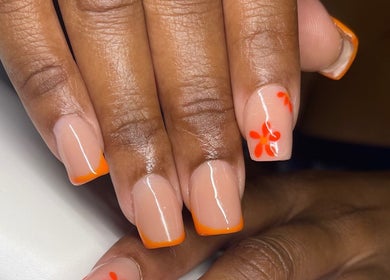 Vibrant orange nail design at TipTastic Nails, Plymouth, Tobago, TT. Stylish floral and tip art.