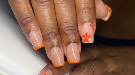 Vibrant orange nail design at TipTastic Nails, Plymouth, Tobago, TT. Stylish floral and tip art.