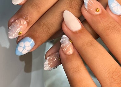 Elegant nail designs at PRESH’S NAIL BAR, Pretoria, Gauteng, ZA showcasing intricate blue and white details.