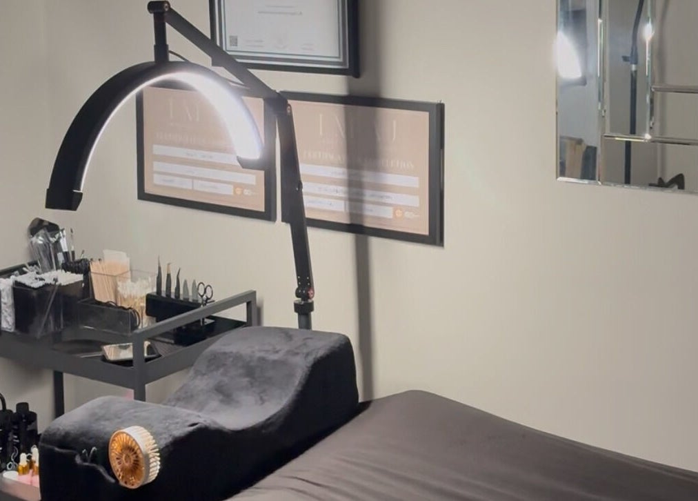 Cozy treatment room at EnvyStudio in Banstead, England, GB, featuring a massage bed and ambient lighting.