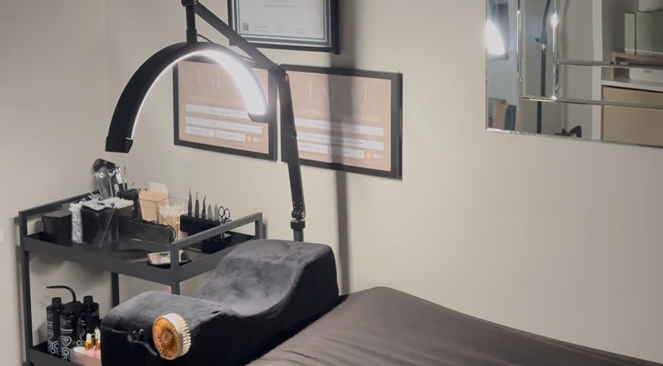 Cozy treatment room at EnvyStudio in Banstead, England, GB, featuring a massage bed and ambient lighting.