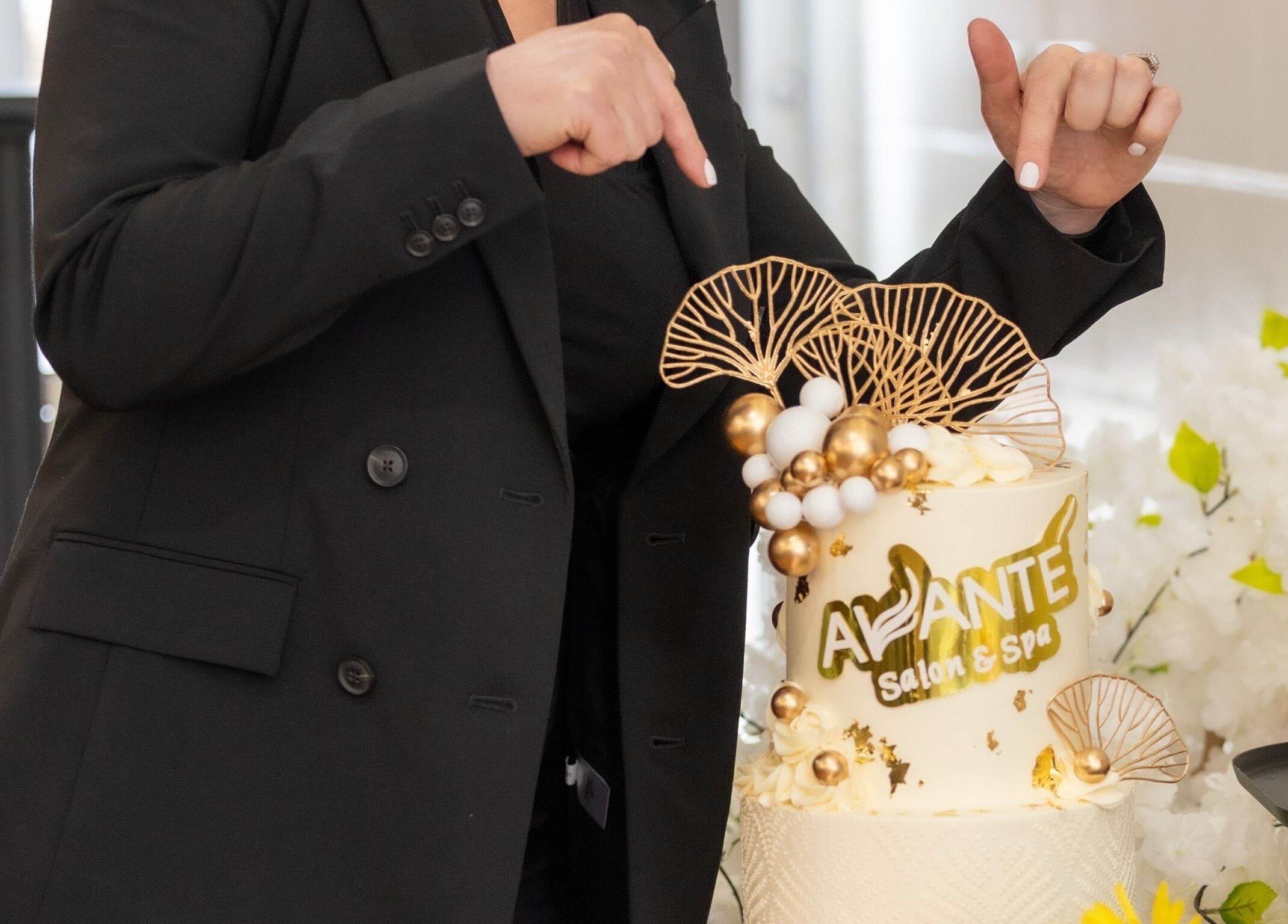 Elegant cake at Avante Salon & Spa in Grimsby, Ontario, CA, adorned with golden accents under spotlight.