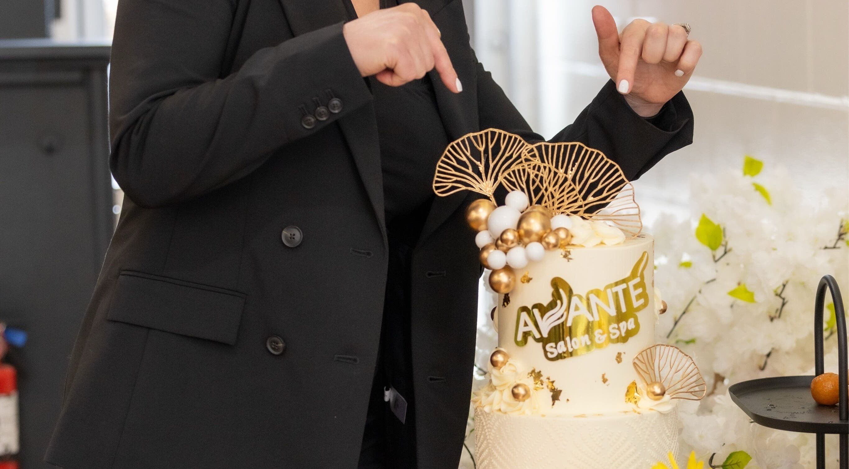 Elegant cake at Avante Salon & Spa in Grimsby, Ontario, CA, adorned with golden accents under spotlight.