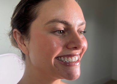 Client showcasing radiant smile after treatment at Blanco Cosmetic Teeth Whitening in Houston, Texas, US.