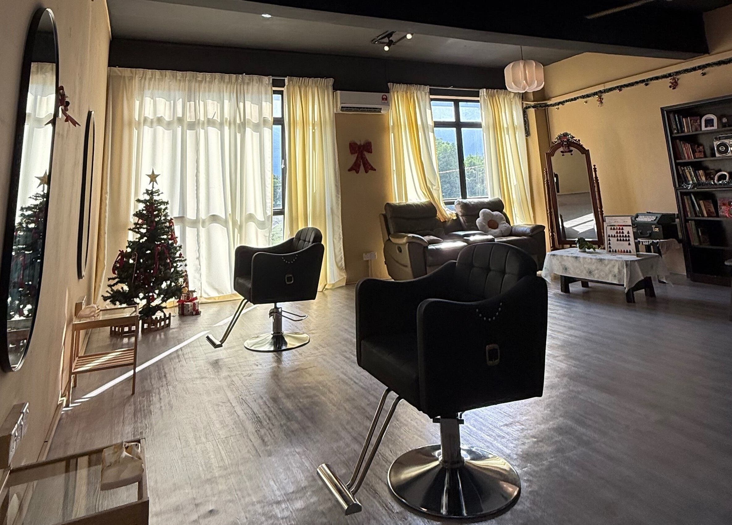 Cozy interior of The Ila’s Hair Salon in Kajang, Selangor, MY, featuring stylish chairs and Christmas decor.