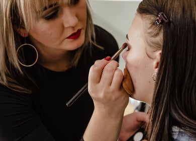 Makeup artist perfecting a client's eye look at The Fern Beauty Salon, Kempton Park, Gauteng, ZA.