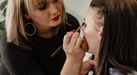 Makeup artist perfecting a client's eye look at The Fern Beauty Salon, Kempton Park, Gauteng, ZA.