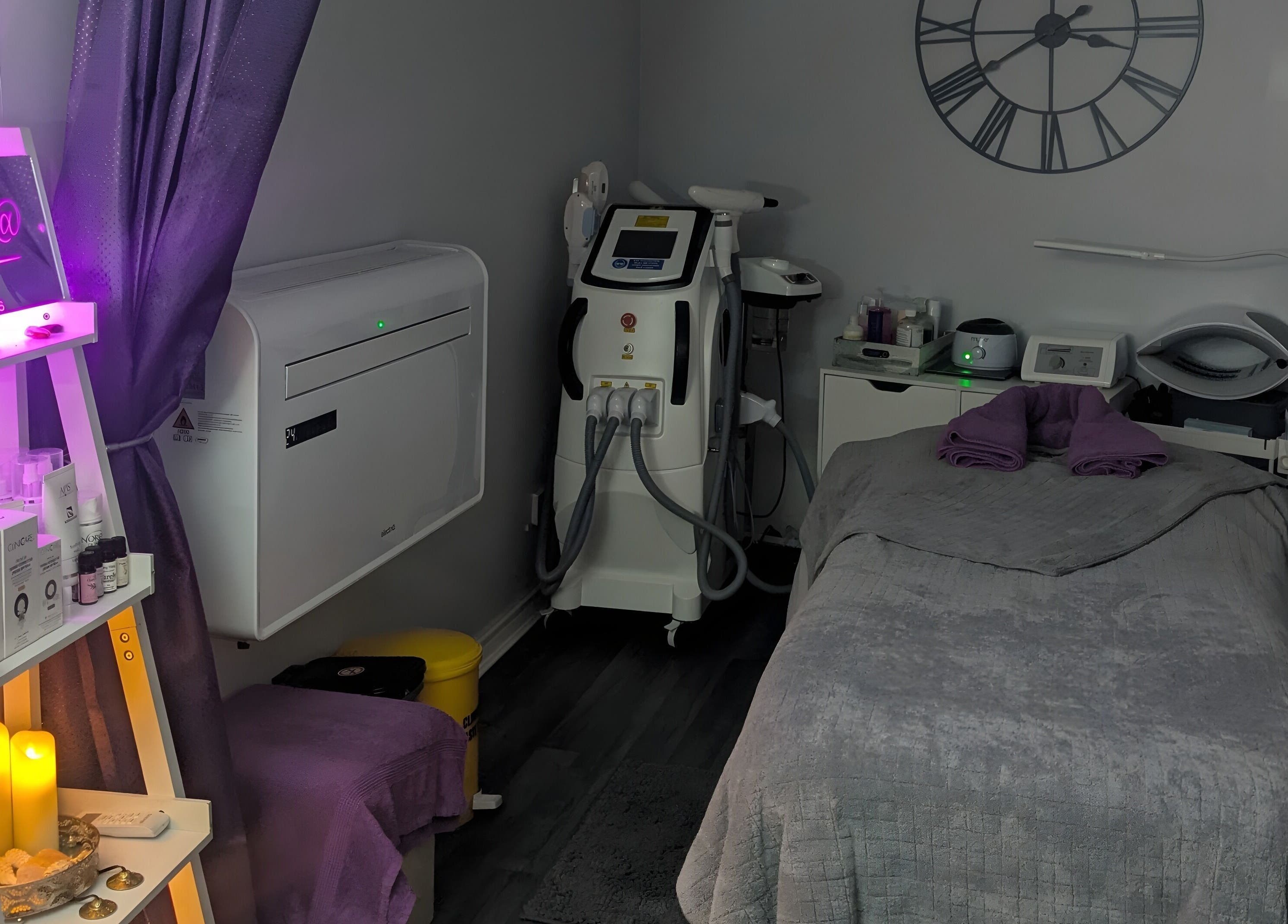 Cozy treatment room at Reflexions, Hockley, England, GB, equipped with spa essentials and purple decor.