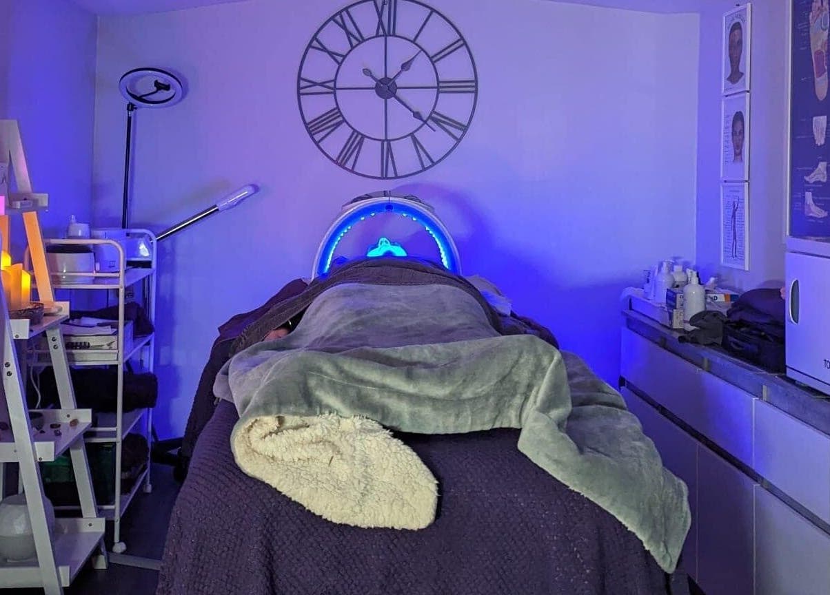 Relaxing spa room at Reflexions, Hockley, England, GB with soft lighting and treatment bed.