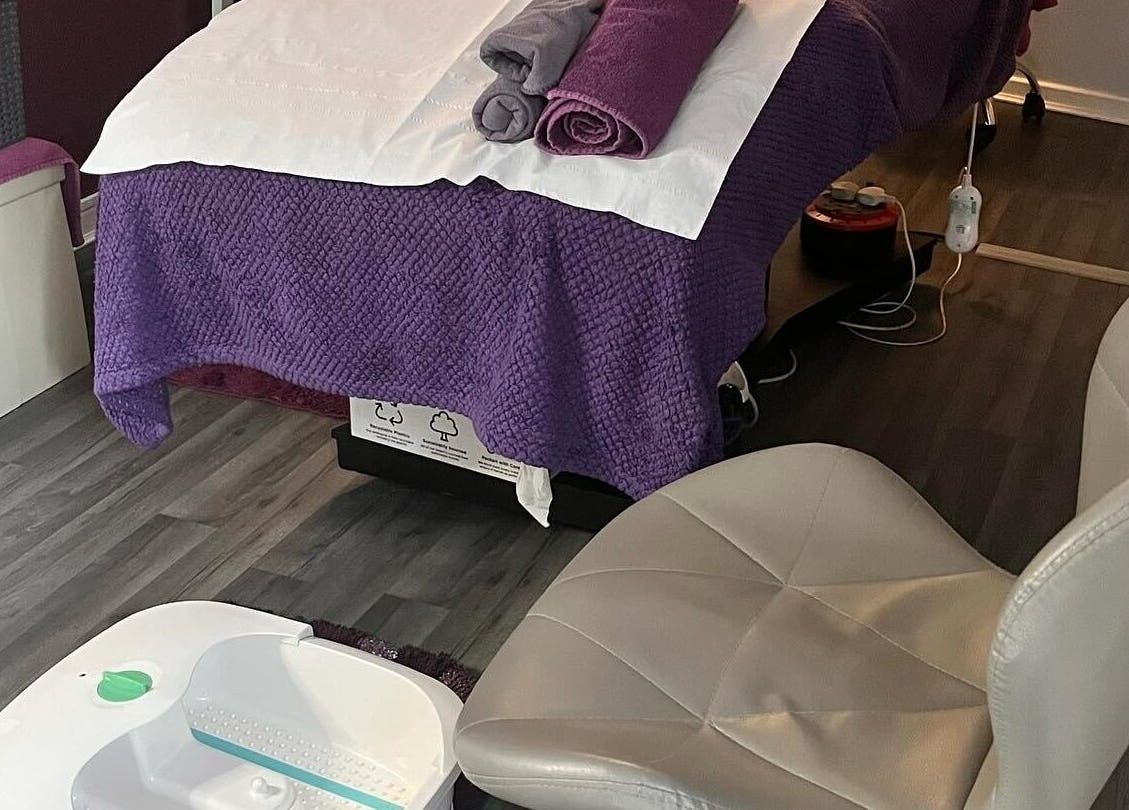 Tranquil spa room at Reflexions, Hockley, England, GB with massage bed and pedicure chair.