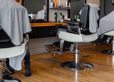 Modern barbershop in Sumqayit, AZ featuring stylish chairs and professional grooming stations.