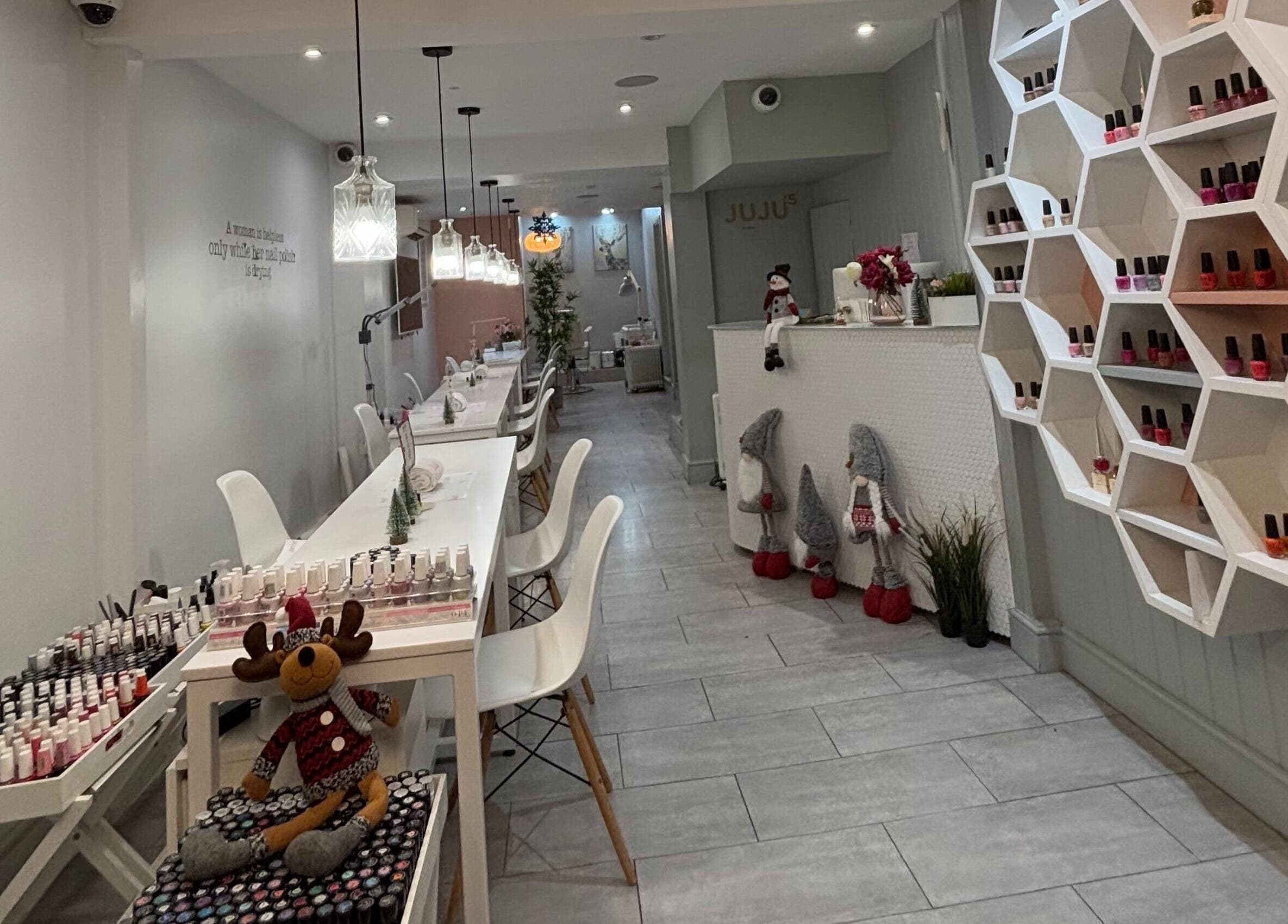 Elegant interior of Juju’s Beauty Salon in London, England, GB showcasing modern decor and cozy ambiance.