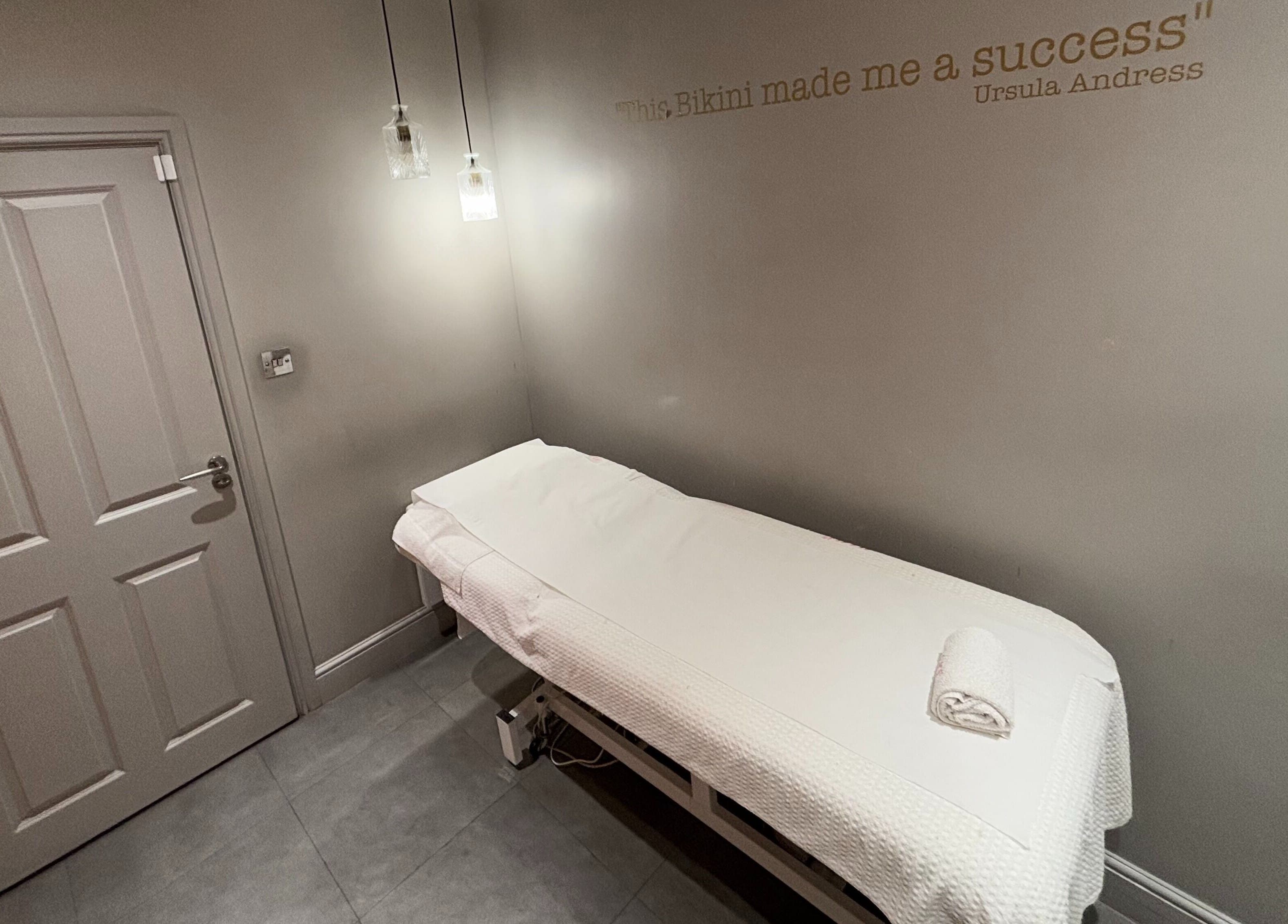 Cozy treatment room at Juju’s Beauty Salon, London, England, GB, featuring a comfortable massage table.