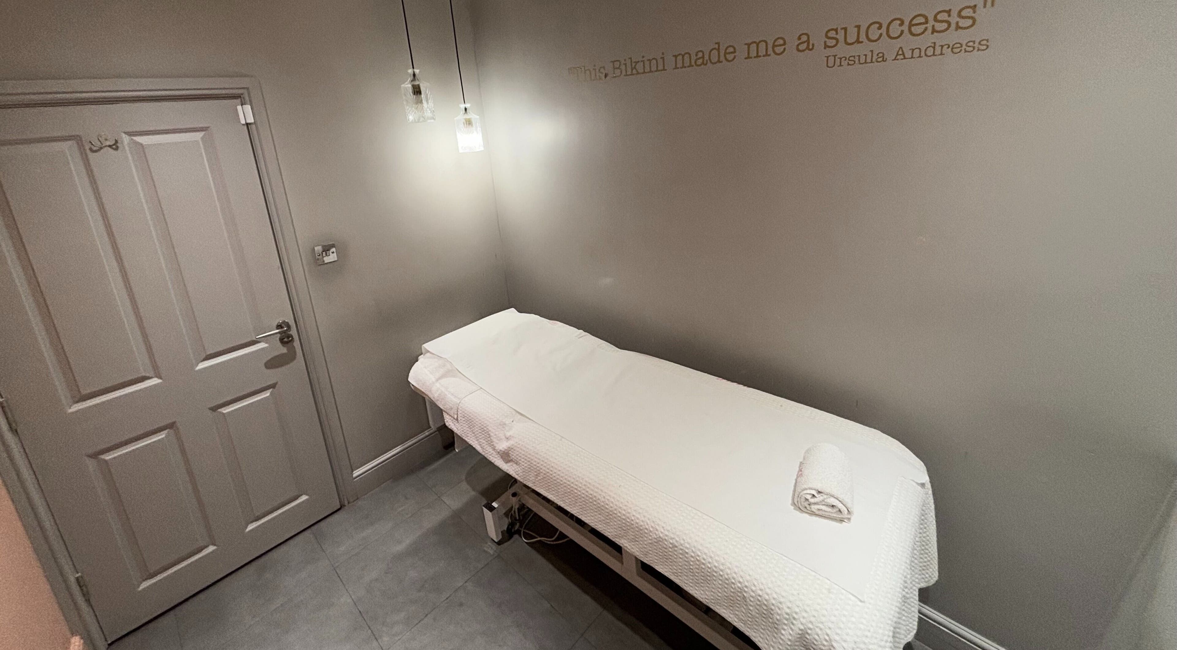Cozy treatment room at Juju’s Beauty Salon, London, England, GB, featuring a comfortable massage table.