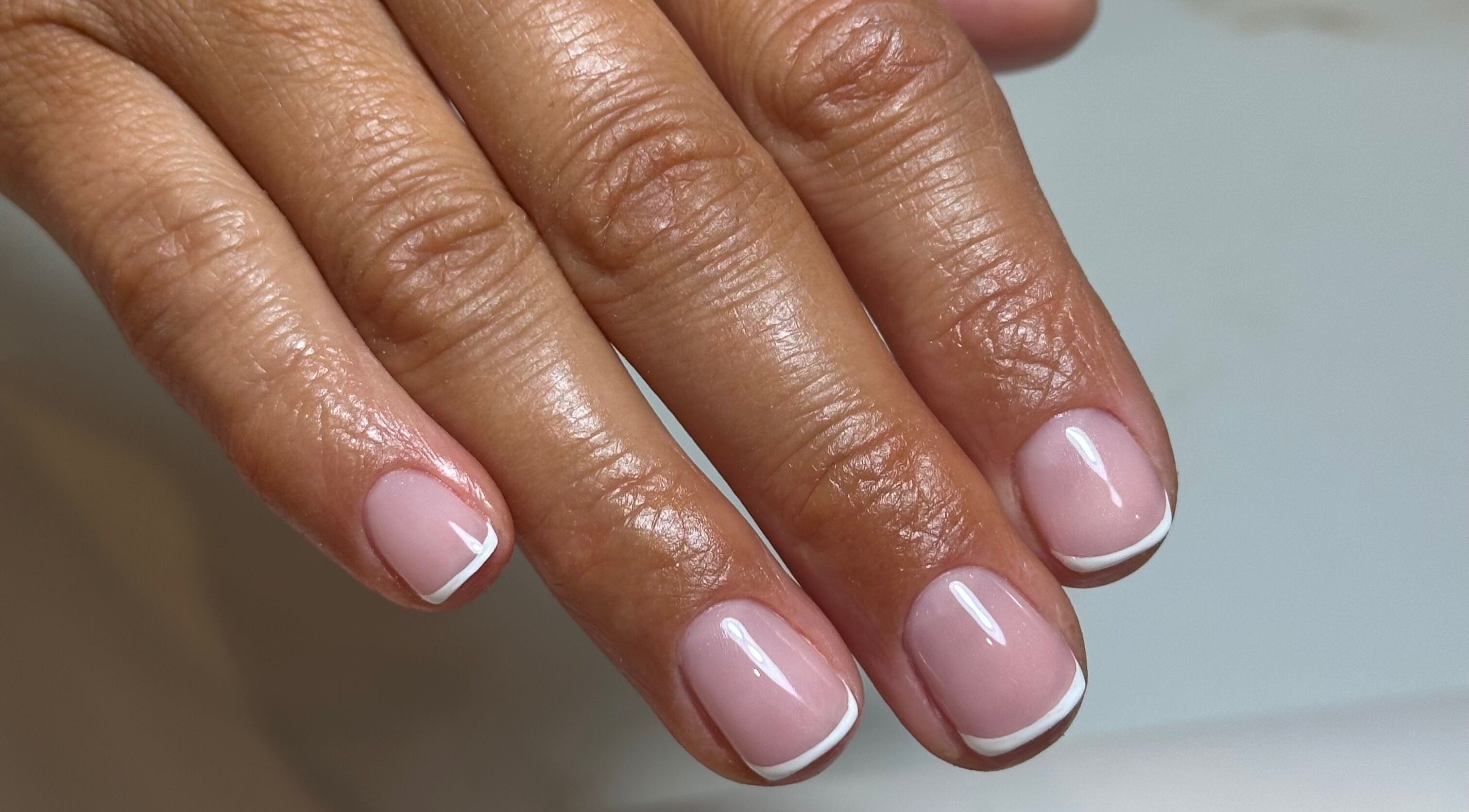 Stylish French manicure by Holly Cookson at Ramsbottom, England, GB, showcasing elegant nail design.