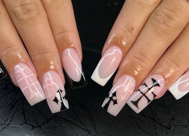 Stylish nail art at Heidi-Jo’s Beauty and Training in Warrington, England, GB with intricate black and white designs.