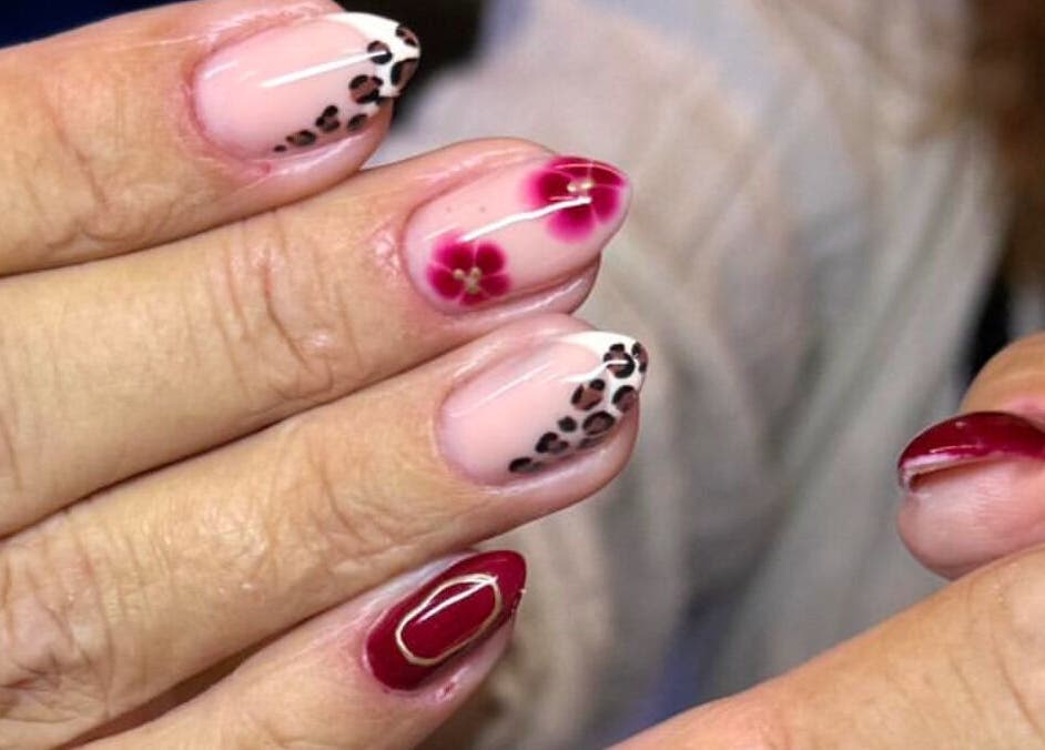 Elegant red and floral nail art by By Bethany in Newport, Wales, GB, showcasing unique design patterns.