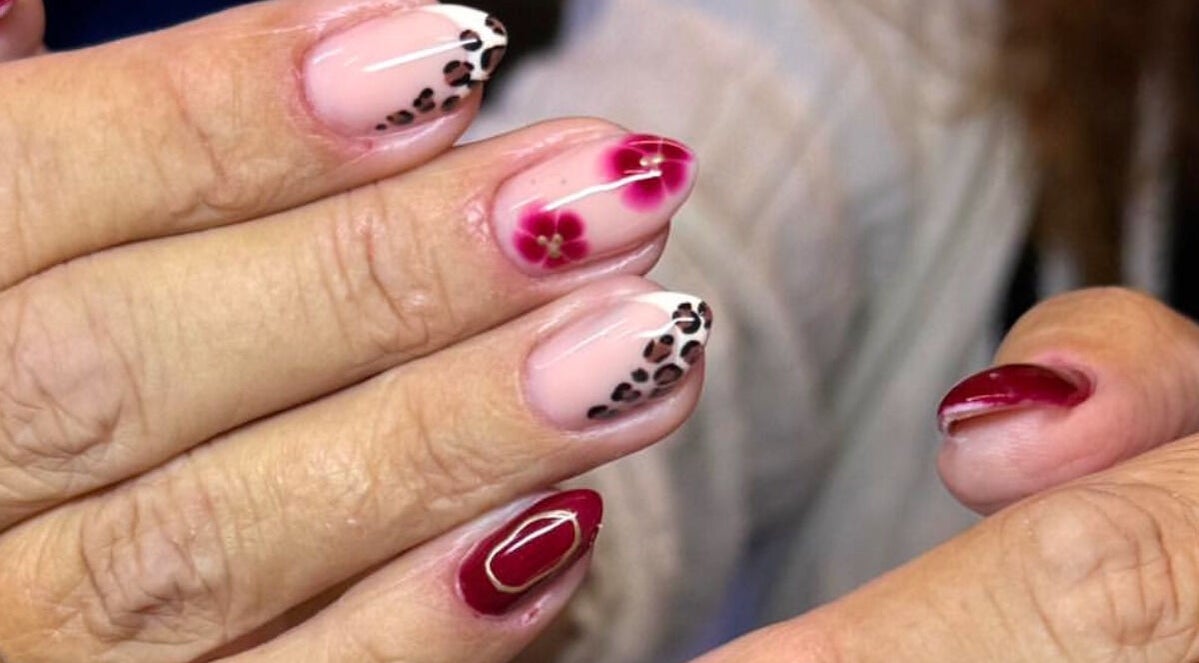 Elegant red and floral nail art by By Bethany in Newport, Wales, GB, showcasing unique design patterns.