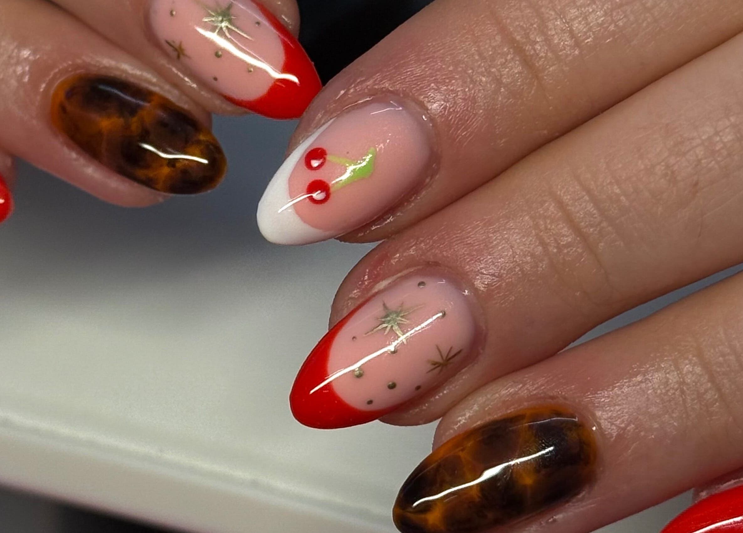 Festive, detailed nail art design at By Bethany, located in Newport, Wales, GB. Featuring red and tortoiseshell accents.