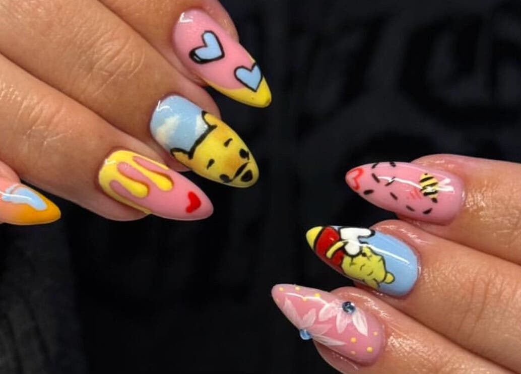 Colorful nail art designs at By Bethany, Newport, Wales, GB, featuring hearts and character figures.
