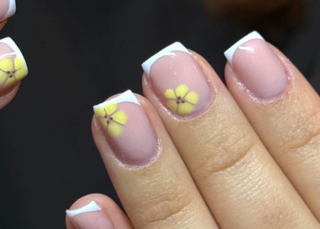 Yellow flower nail art at By Bethany, Newport, Wales, GB showcasing French tips and elegant design.