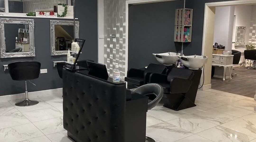 Modern salon interior at Sharon O'Brien At Eclipse Hair and Beauty, Euxton, England, GB with sleek black chairs.