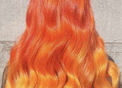 Vibrant orange wavy hair styled at Sharon O'Brien At Eclipse Hair and Beauty, Euxton, England, GB.