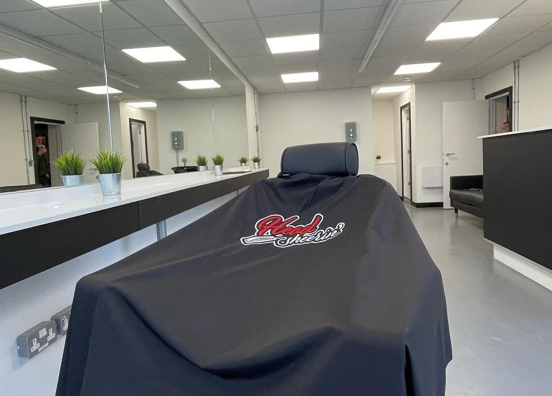 Interior of HeadsheerinHQ in Bridport, England, showcasing modern salon chair and minimalist decor.