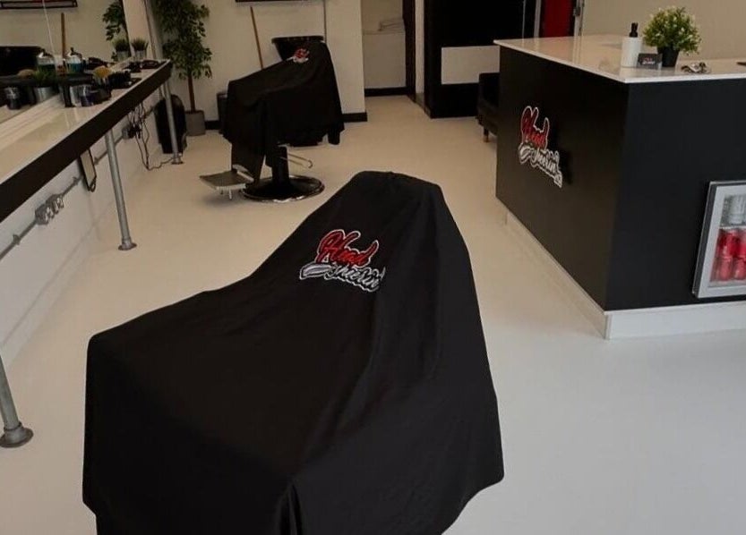 Modern salon interior at HeadsheerinHQ in Bridport, England, GB featuring stylish chairs and sleek decor.