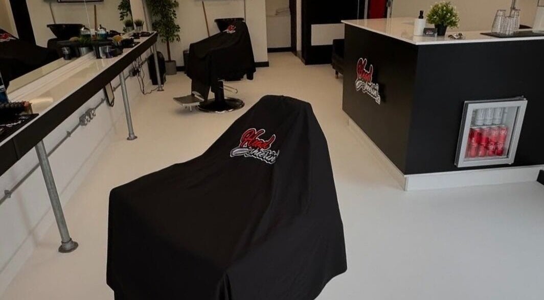 Modern salon interior at HeadsheerinHQ in Bridport, England, GB featuring stylish chairs and sleek decor.