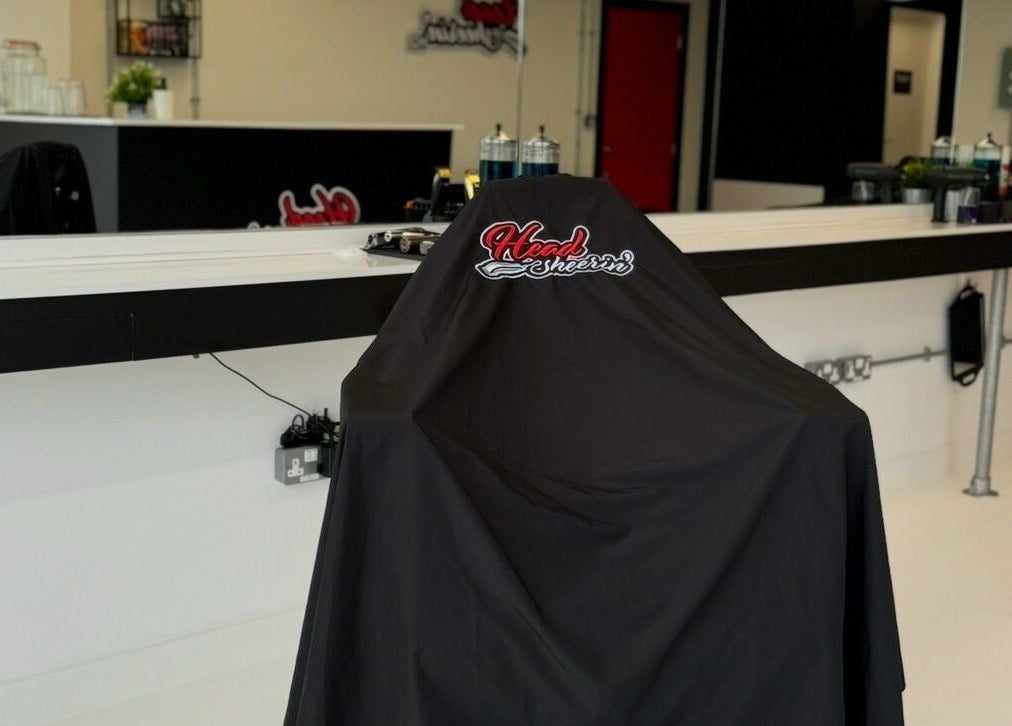 Salon chair with HeadsheerinHQ branding at Bridport, England, GB, showcasing modern elegance.