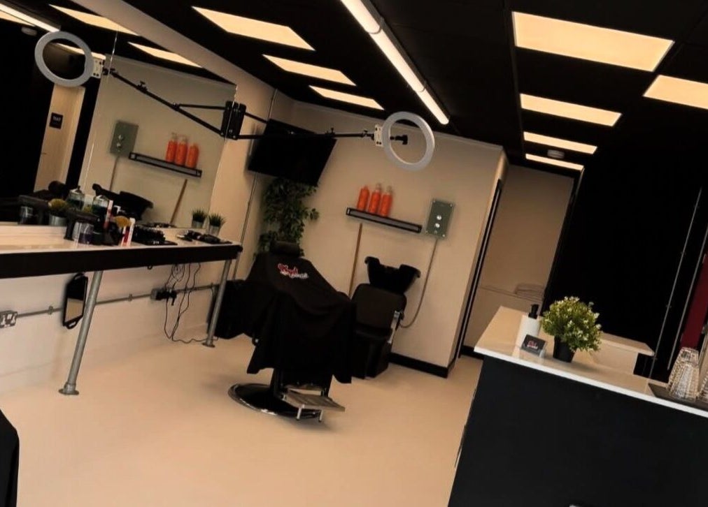 Modern salon interior at HeadsheerinHQ, Bridport, England with sleek furnishings and professional equipment.