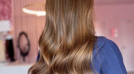 Glossy brown waves hairstyle at Hair by Susie Hancock, Ferndown, England, GB, showcasing elegant styling.