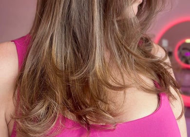 Stylish brown hair at Hair by Susie Hancock, Ferndown, England, GB with vibrant pink decor.