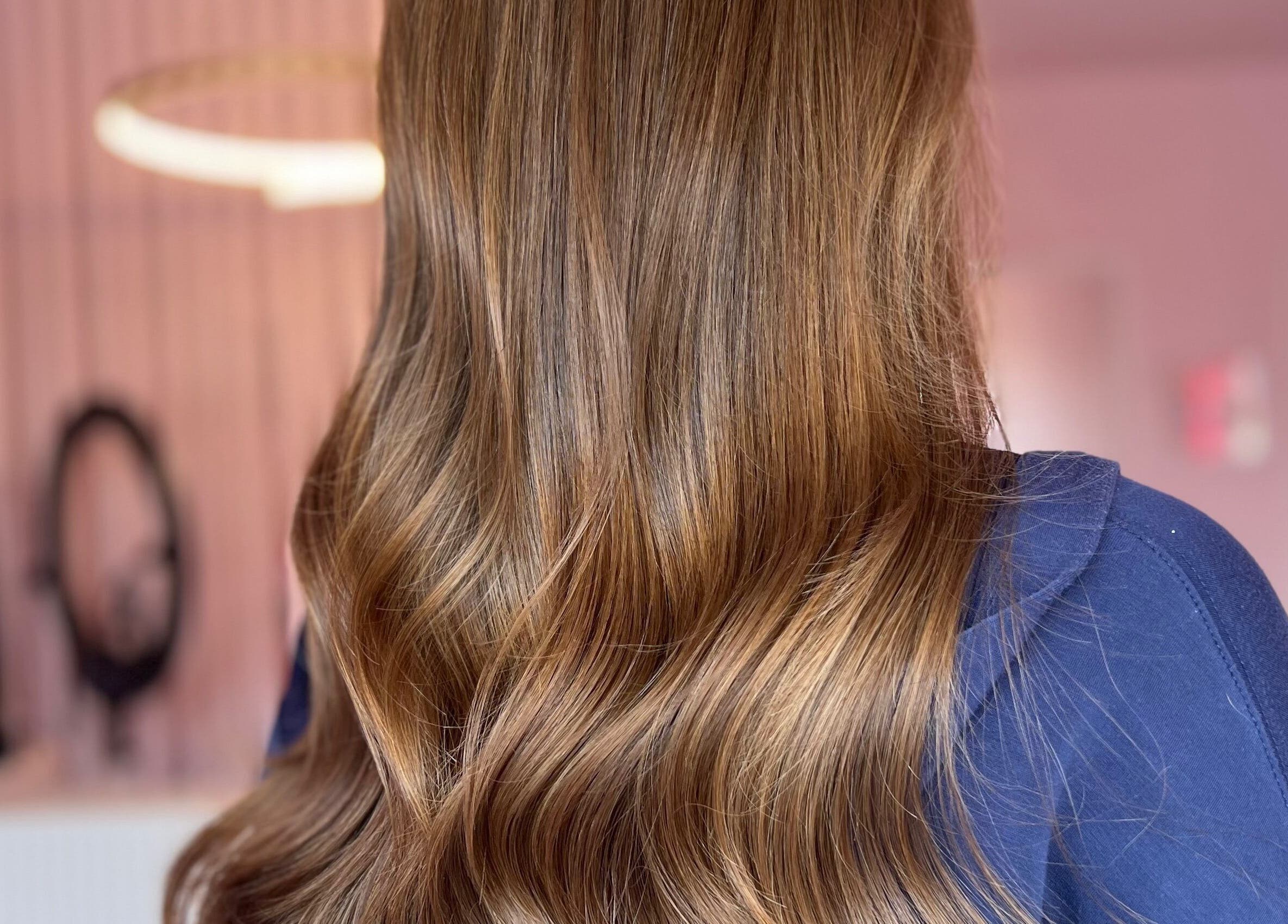 Elegant wavy hairstyle at Hair by Susie Hancock, Ferndown, England, GB, showcasing vibrant brown hair.