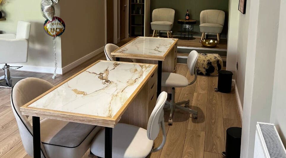 Chic salon tables at My Brow in Ramsbottom, England, GB, with sleek marble surfaces and comfortable seating.