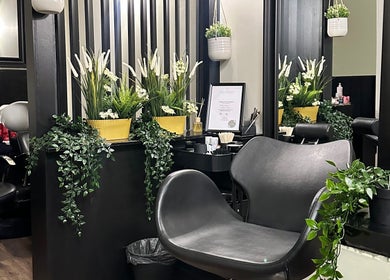 Chic interior of Brows and Lashlifts By Emma, Birmingham, England, GB with lush plants and contemporary chairs.