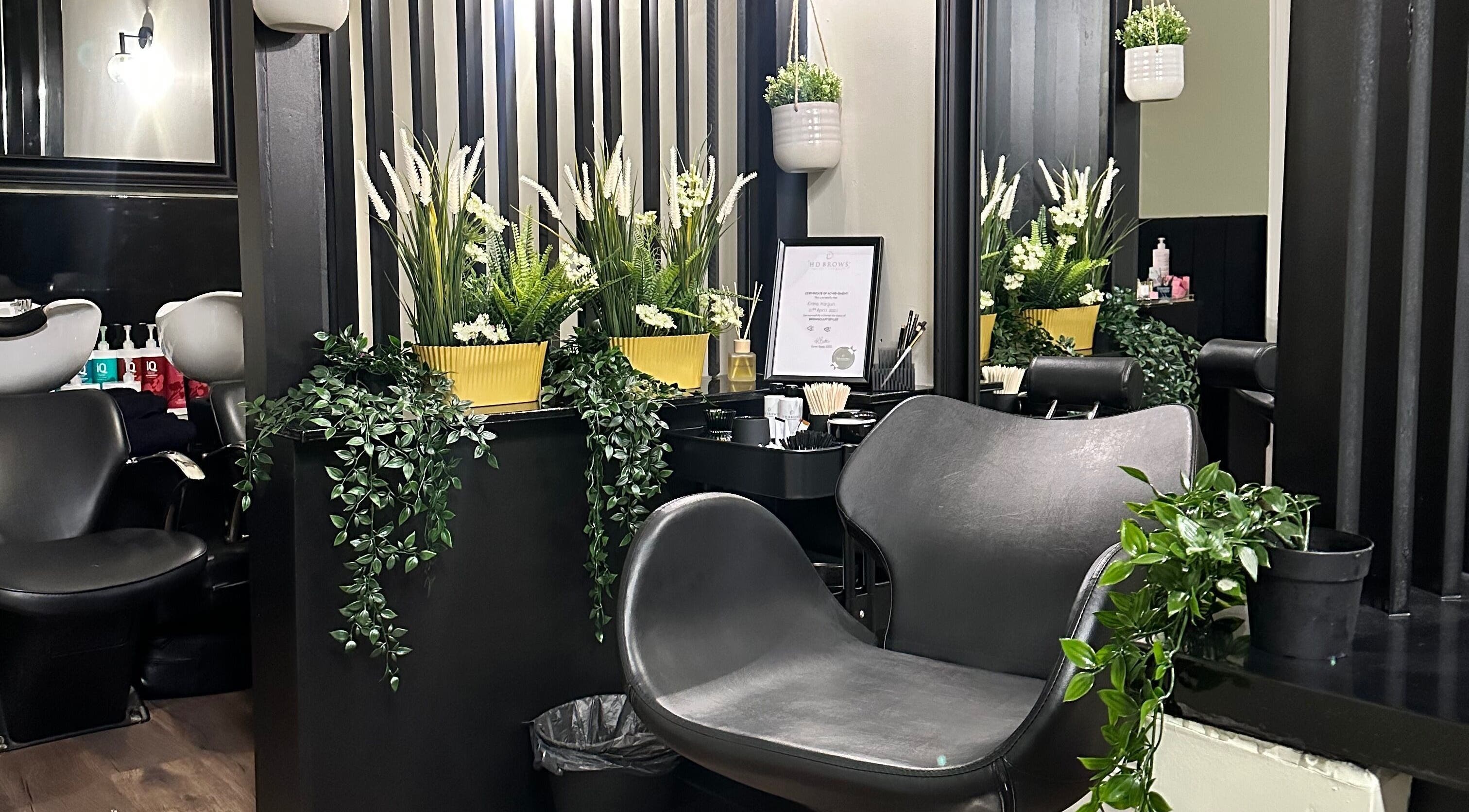 Chic interior of Brows and Lashlifts By Emma, Birmingham, England, GB with lush plants and contemporary chairs.