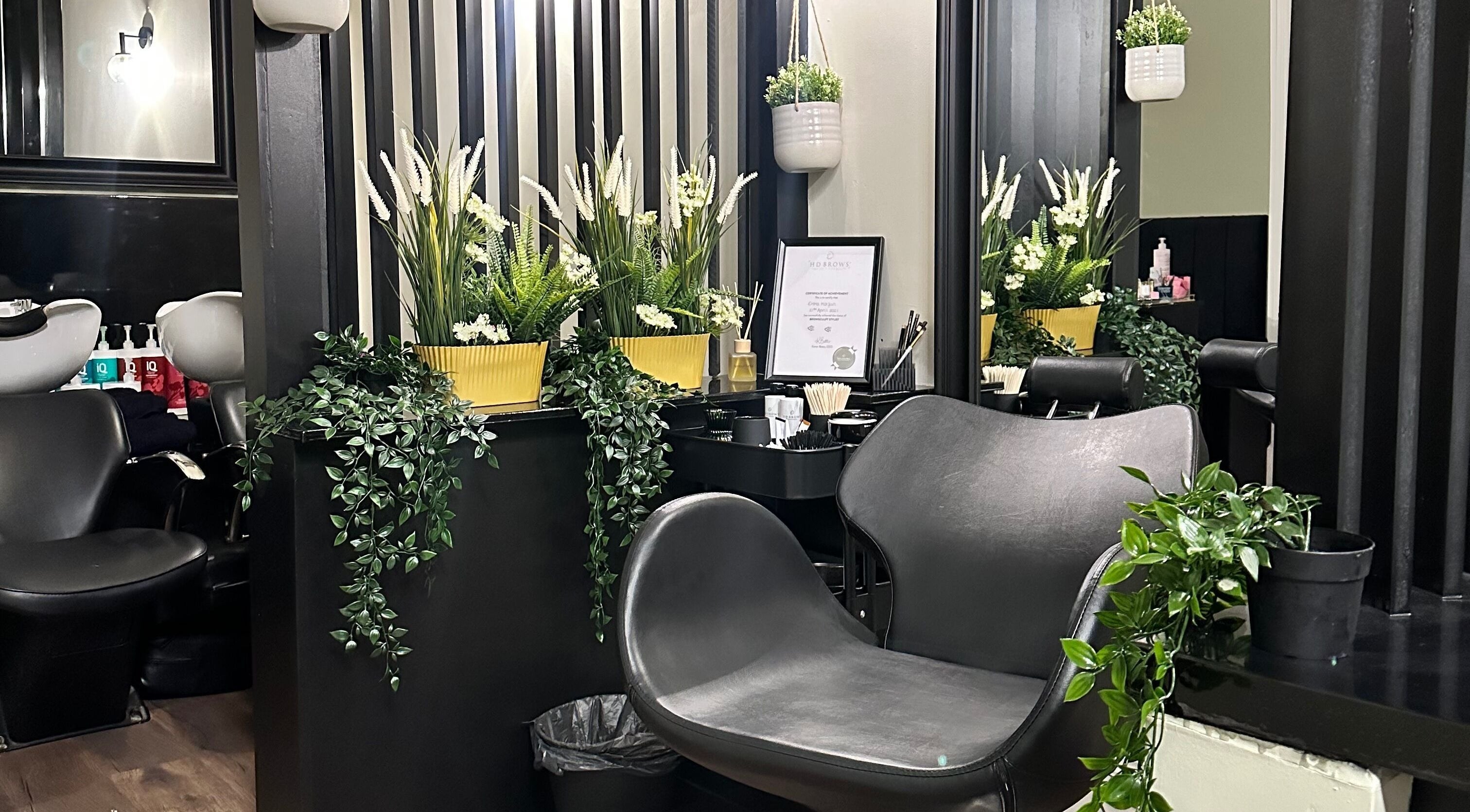 Chic interior of Brows and Lashlifts By Emma, Birmingham, England, GB with lush plants and contemporary chairs.