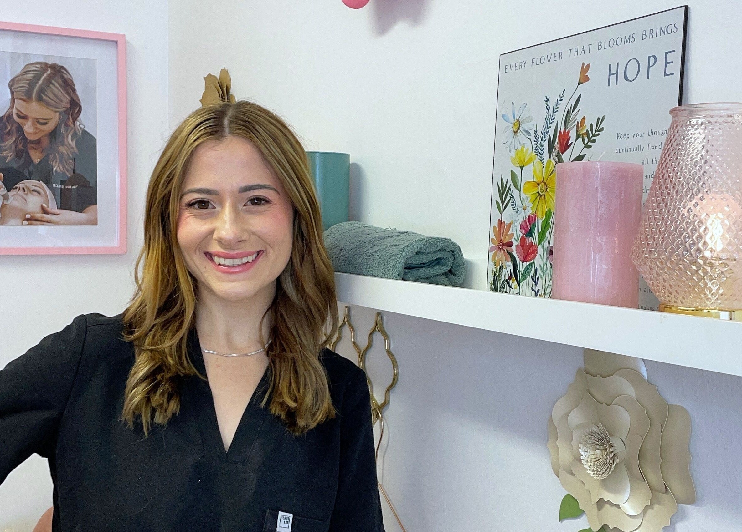 Smiling beautician at Bloom by Shay, Kloof, Kwazulu-natal, ZA. Cozy, floral decor in treatment room.