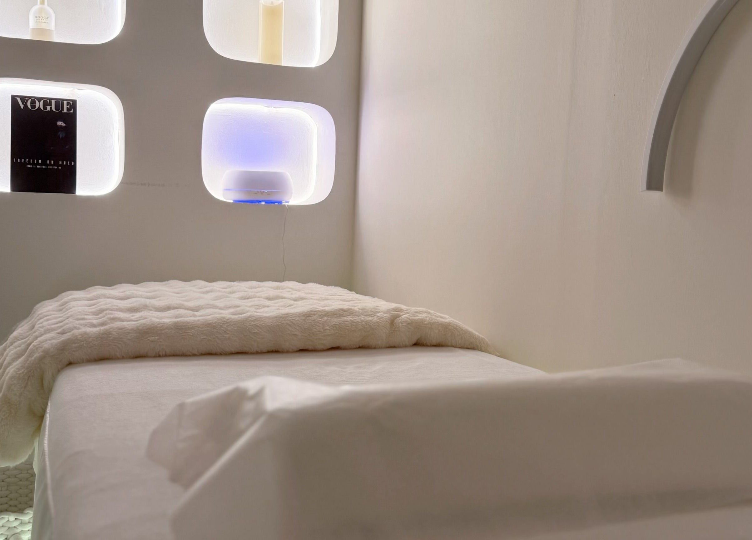 Cozy treatment room at Pocobeauty in Singapore, SG, with soft lighting and plush bedding.