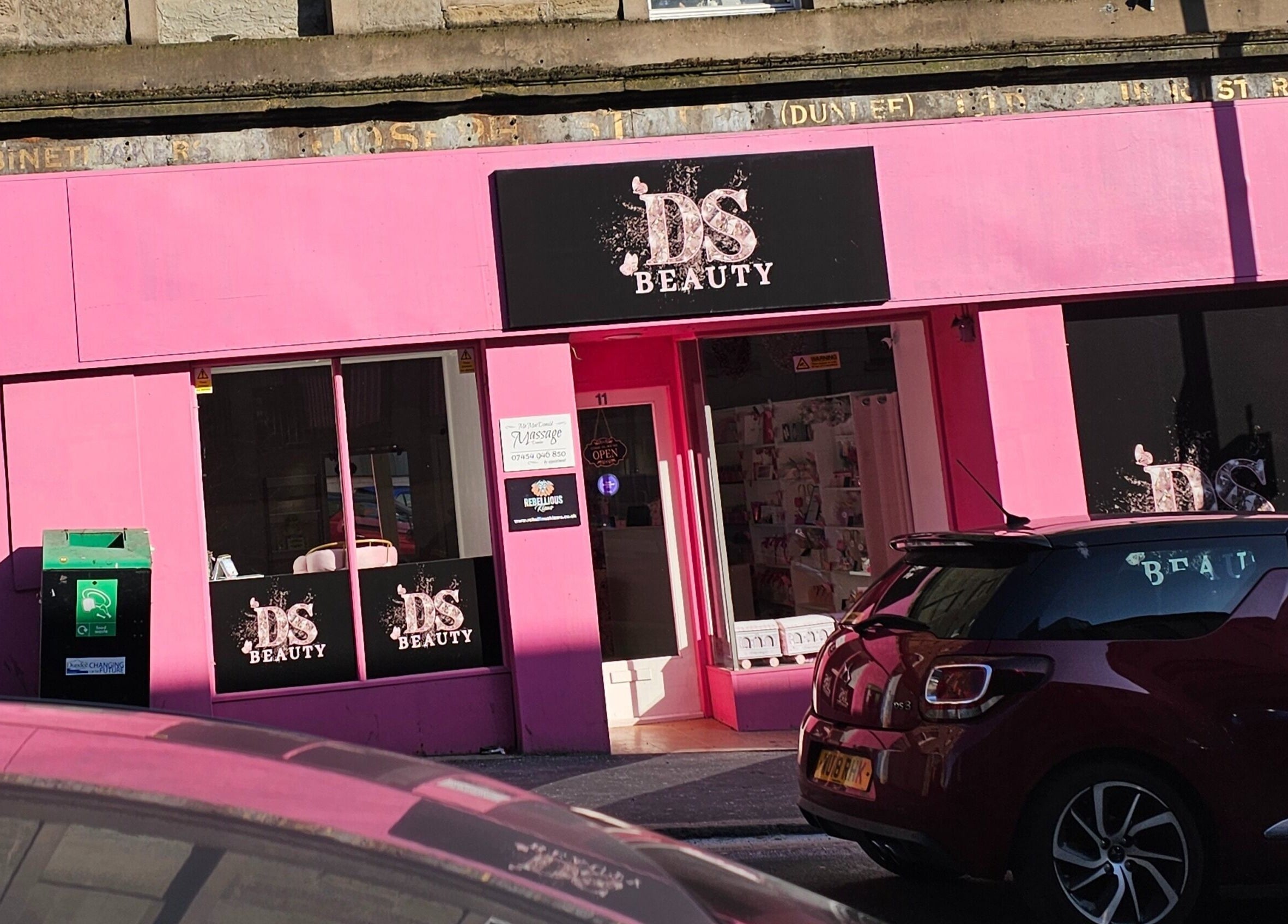 Exterior of Scrunch.N.Curl in Dundee, Scotland, GB, showcasing vibrant pink facade and stylish signage.
