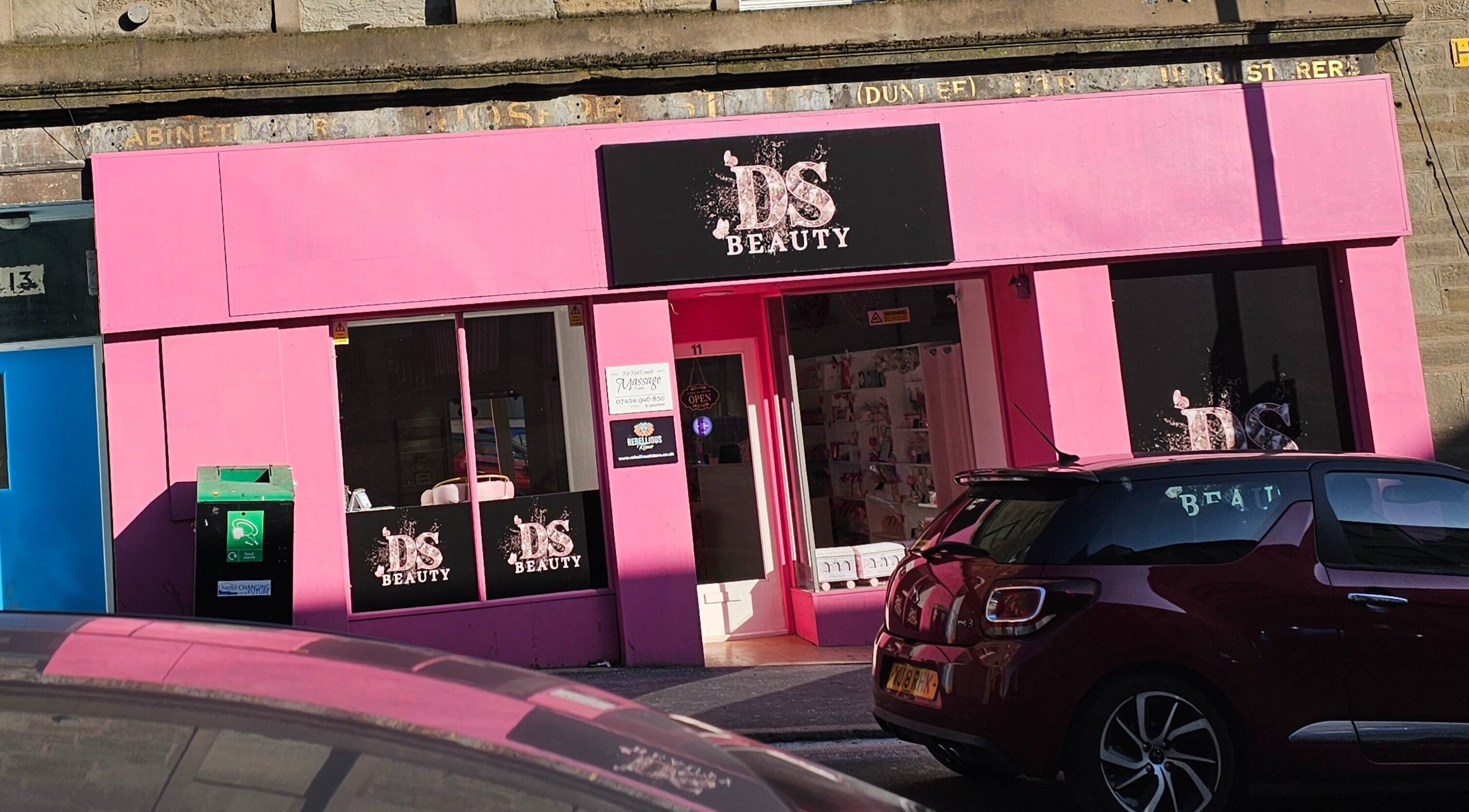 Exterior of Scrunch.N.Curl in Dundee, Scotland, GB, showcasing vibrant pink facade and stylish signage.
