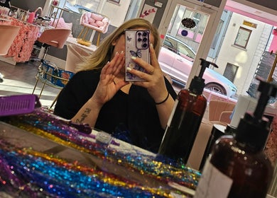 Inside Scrunch.N.Curl, Dundee, Scotland, GB showcasing colorful salon interior and mirror view.