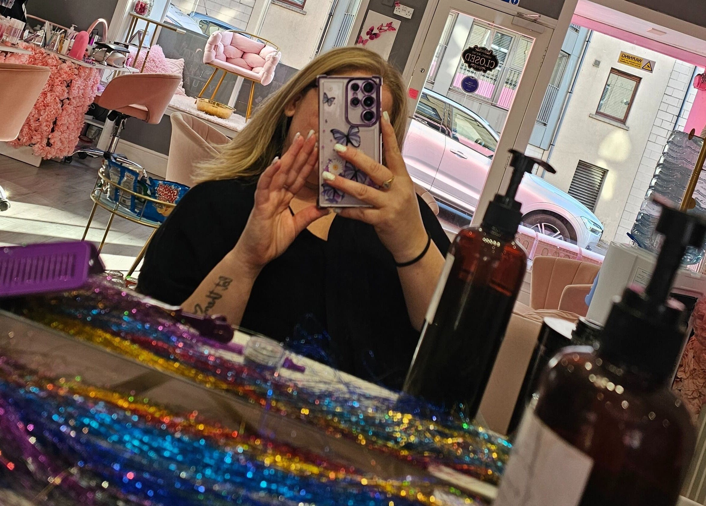 Inside Scrunch.N.Curl, Dundee, Scotland, GB showcasing colorful salon interior and mirror view.