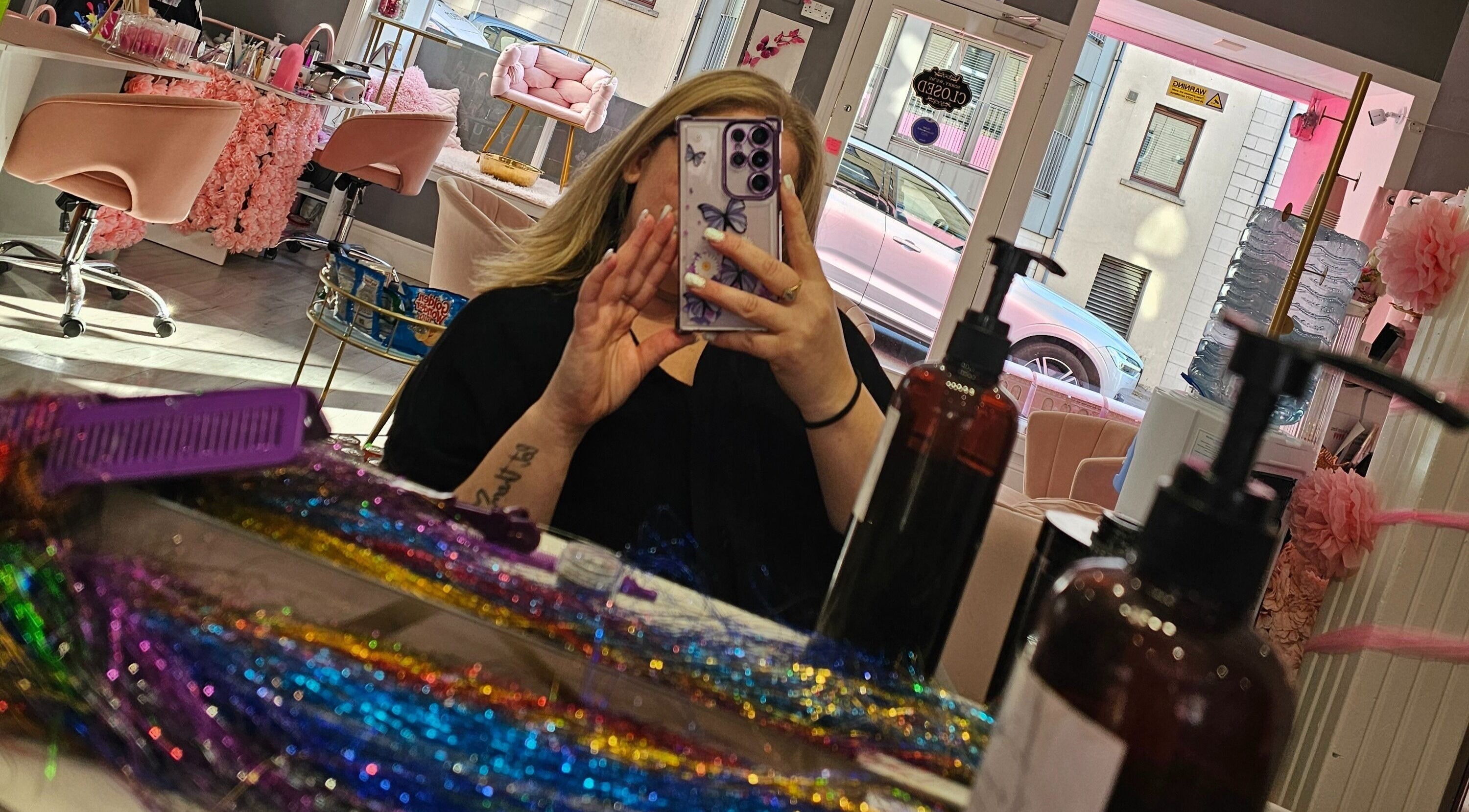 Inside Scrunch.N.Curl, Dundee, Scotland, GB showcasing colorful salon interior and mirror view.